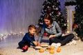 Mom and young boy open Christmas presents Christmas tree new year holiday Royalty Free Stock Photo