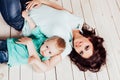 Mom and young boy son lying on the wooden floor Royalty Free Stock Photo