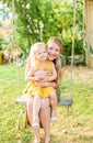 Mom and young daughter on backyard swing Royalty Free Stock Photo