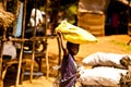 MOMBASSA, KENYA. DECEMBER 18, 2011: Kenyan girl carries a bag of rice on her head.