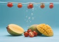 the moment when cherry tomato and mango slice fall into water. Royalty Free Stock Photo