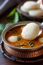 The moment of dipping idli into a bowl of sambar - a traditional South Indian dish for breakfast Royalty Free Stock Photo