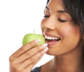 The moment before the first delicious bite. A pretty young woman biting into a crunchy apple. Royalty Free Stock Photo