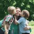 Moment of happy mother! Two children sons kissing mom Royalty Free Stock Photo