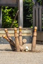 Moment of the impact of a small wooden skittle or bitllot against larger wooden skittles in the traditional Catalan bowling game Royalty Free Stock Photo