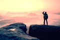 Moment of loneliness. Man on the rock empires and watch over the misty and foggy morning valley to Sun Royalty Free Stock Photo