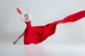 In moment of pure flamenco artistry, female dancer in vibrant red dress and fan, performing flamenco with elegance Royalty Free Stock Photo