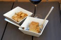 A cheese appetizer accompanied by a glass of red wine. Royalty Free Stock Photo