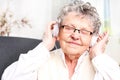 Moment of relaxation, rest grandmother listening to music.