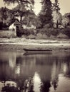 Moment of reverie. A scenic view of a small boat floating on water with reflection and a luxurious nature