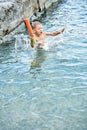 Moment of small boy diving into water while jumping in sea Royalty Free Stock Photo