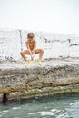 Moment of small boy jumping from pier into sea water Royalty Free Stock Photo