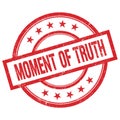 MOMENT OF TRUTH text written on red vintage round stamp