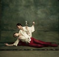 Two young female ballet dancers like duelists with swords. Ballet and contemporary choreography concept. Creative art Royalty Free Stock Photo