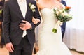 Moment in wedding, bride and groom holding hands with bouquet Royalty Free Stock Photo