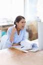 That moment when you find out your hard work paid off. An excited businesswoman doing a fist pump while sitting at her Royalty Free Stock Photo