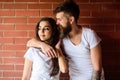 Moments of intimacy. Couple find place to be alone. Couple in love hugs brick wall background. Girl and hipster romantic Royalty Free Stock Photo