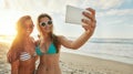 Moments to be remembered. two friends taking selfies while hanging out at the beach. Royalty Free Stock Photo