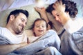 Mommy and daddy hiding under blanket with me. Royalty Free Stock Photo