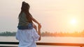 Mommy holds daughter on shoulders looking at calm river Royalty Free Stock Photo