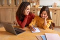 Mommy hugging her smart daughter while she writing homework indoor Royalty Free Stock Photo
