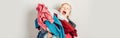 Mommy little helper. Adorable funny tired child arranging organazing clothing. Kid holding messy stack pile of clothes things. Royalty Free Stock Photo