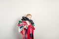 Mommy little helper. Cute Caucasian girl sorting clothes. Adorable funny child arranging organazing clothing. Kid holding messy Royalty Free Stock Photo