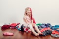 Mommy little helper. Cute Caucasian girl sorting clothes. Adorable funny child arranging organazing clothings. Kid with messy