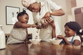 Mommy please add more. a young mother preparing cereal for her two adorable young daughters at home.