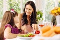 Dark-haired mommy taking care of her girl while having lunch Royalty Free Stock Photo