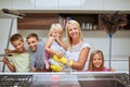 Moms got many helpers to keep their home sparkling clean. Portrait of a mother and her kids doing chores together at Royalty Free Stock Photo