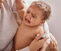 Moms always got you. a baby crying while having her temperature checked by her mother. Royalty Free Stock Photo