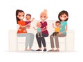 Moms are holding babies in their arms while sitting on the sofa. Communication of young mothers Royalty Free Stock Photo