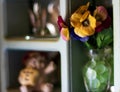 Moms nicknack shelf with flowers and ceramic animals Royalty Free Stock Photo