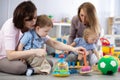 Moms with their babies in nursery Royalty Free Stock Photo