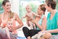 Moms and their babies practicing diaper change Royalty Free Stock Photo