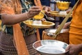 Mon people offer jasmine rice and food to monk, Sangkhlaburi Royalty Free Stock Photo