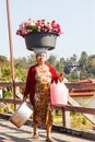 Mon woman carrying flower on head