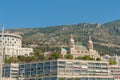 Monaco, Monaco - July 08 2008: Hotel de Paris and Casino de Monte-Carlo with tall mountains in the backgroud..