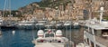 Monaco, Monaco - July 08 2008: Luxury yachts in the Monaco harbor with large apartment complexes in the background..
