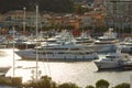 Monaco, Monte Carlo, 18 October 2022: Sunset panorama of port Hercule, moored mega yacht, sun reflection