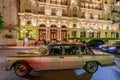 Monaco, Monte Carlo, 21 August 2019: Vintage Mercedes Benz car near the hotel Paris with night illumination, lights of