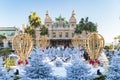 Monaco, Monte-Carlo, 25 December 2019: The square Casino Monte-Carlo at sunset, white Christmas trees, hotel the Paris, sunny day Royalty Free Stock Photo