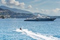 Monaco, Monte-Carlo, most expensive mega yacht on sea, sunny day, Jet Ski, mountains on background Royalty Free Stock Photo