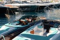 Monaco, Monte Carlo, 28 September 2022 - Riva boats in a row and a lot of luxury mega yachts at the famous motorboat Royalty Free Stock Photo