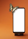 Monarch Butterfly sits on a smartphone, on orange background