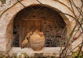 Monastery Cat Examining Large Ceramic Urn, Greece Royalty Free Stock Photo