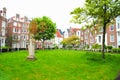 Monastery courtyard with a statue, surrounded by houses Amsterdam