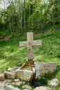 A monastery in the green forest, cross on a water spring