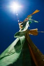 Monastery prayer flag pole in sun